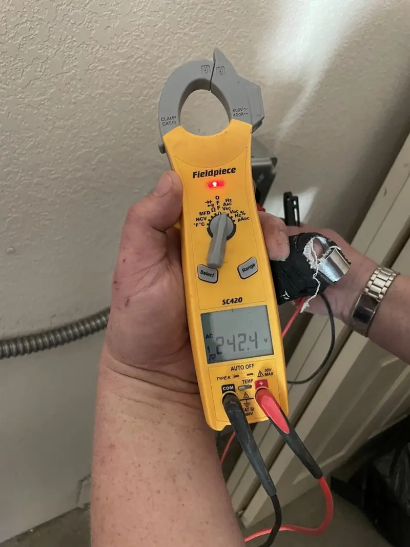 Voltage testing with clamp meter during Outlet Installation in Grandview